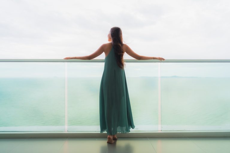 beautiful-portrait-young-asian-woman-happy-smile-relax-balcony-with-sea-ocean(1)